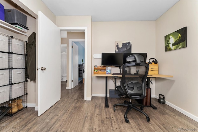 home office with wood finished floors and baseboards