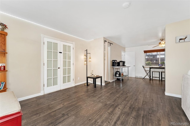 living area featuring wood finished floors, french doors, a ceiling fan, and baseboards