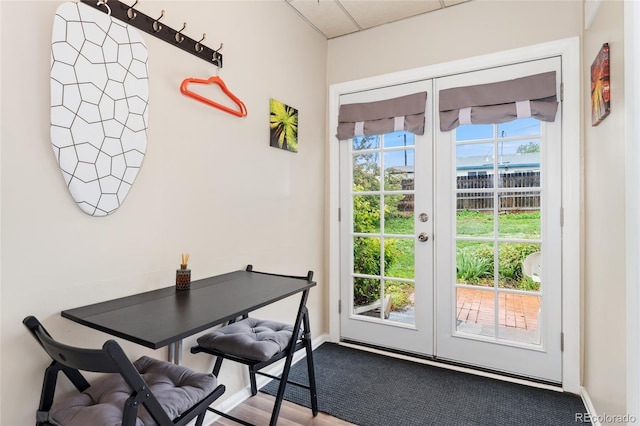 doorway with french doors, baseboards, and a water view