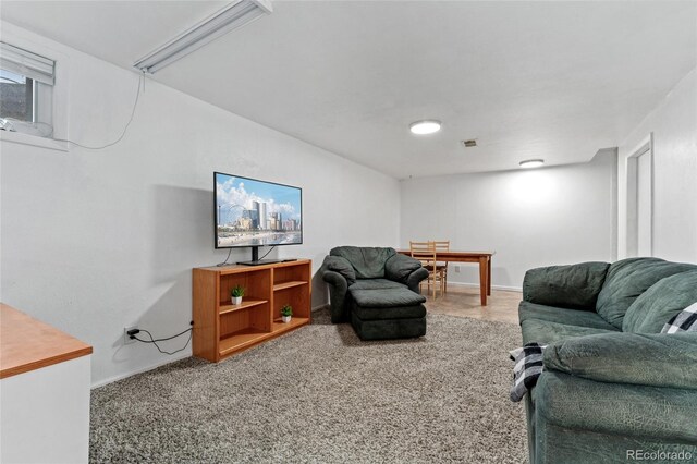 living area with baseboards, carpet flooring, and attic access