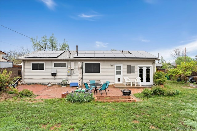back of house featuring french doors, a patio area, and roof mounted solar panels