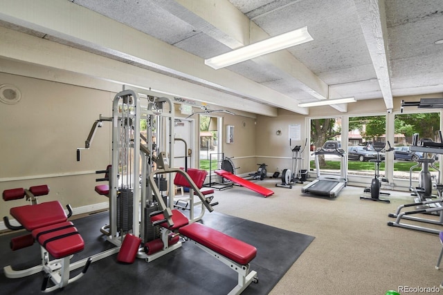 gym with a healthy amount of sunlight and carpet floors