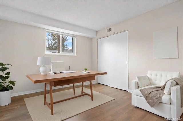 office area featuring hardwood / wood-style flooring and a textured ceiling