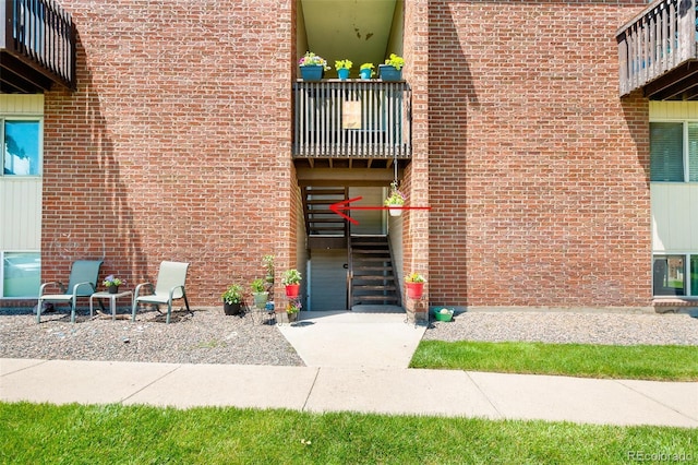 3613 S Sheridan Blvd Unit 10, Denver, CO 80235 - doorway to property with a balcony and brick siding