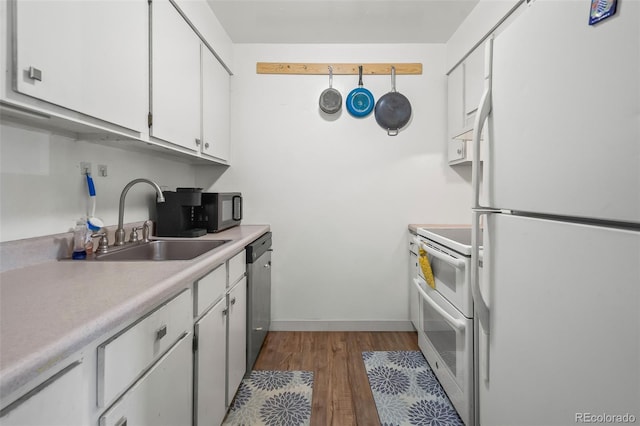 3613 S Sheridan Blvd Unit 10, Denver, CO 80235 - kitchen with white appliances, dark wood finished floors, light countertops, and white cabinets
