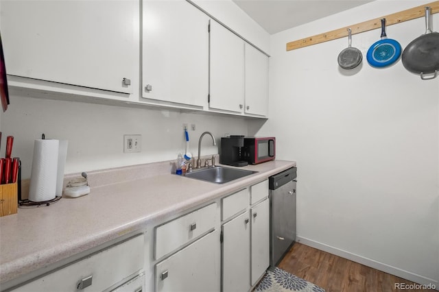 3613 S Sheridan Blvd Unit 10, Denver, CO 80235 - kitchen featuring dishwasher, white cabinetry, light countertops, and wood finished floors