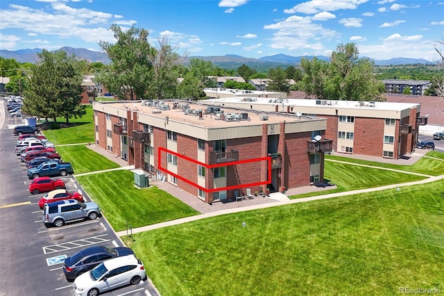 3613 S Sheridan Blvd Unit 10, Denver, CO 80235 - view of building exterior featuring a mountain view and uncovered parking