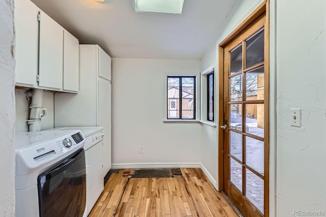 laundry room with light hardwood / wood-style floors and cabinets