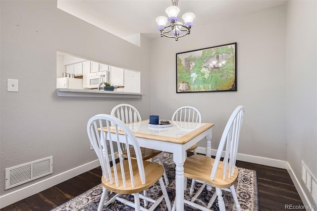 9653 Deerhorn Ct Unit 143, Parker, CO 80134 - dining area with dark wood finished floors and a chandelier