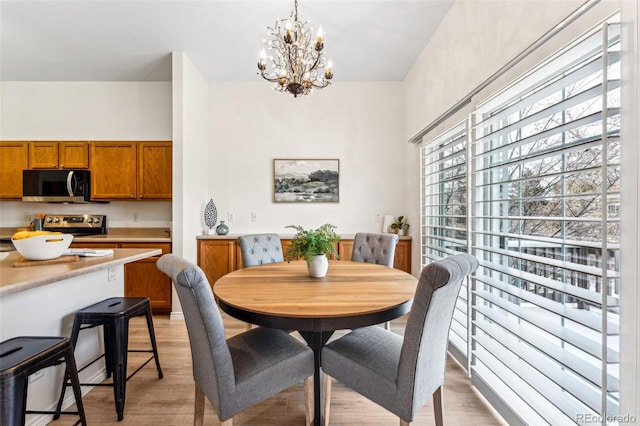 dining room featuring a chandelier and light wood-type flooring