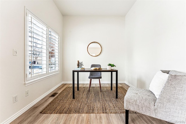 home office with wood-type flooring