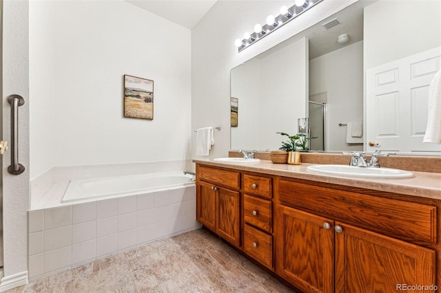 bathroom with vanity and independent shower and bath