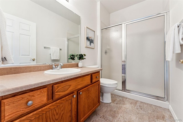 bathroom with vanity, an enclosed shower, and toilet