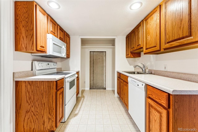 kitchen featuring white appliances and sink