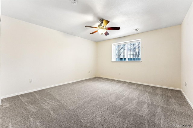 spare room featuring ceiling fan and carpet