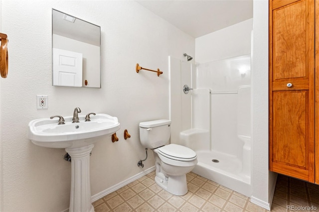 bathroom with toilet and walk in shower