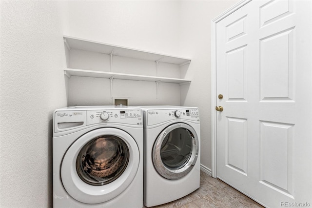 clothes washing area with washer and clothes dryer