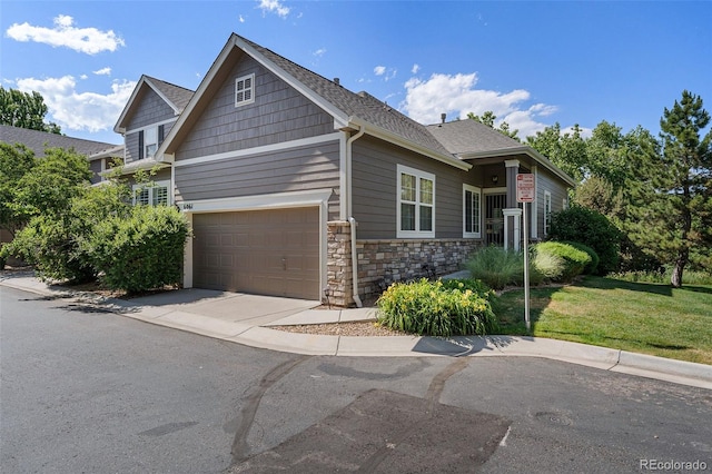 craftsman house with a front yard and a garage