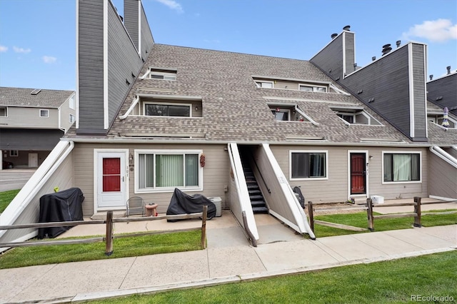 5250 S Huron Way Unit 1-204, Littleton, CO 80120 - back of house with a shingled roof, stairway, a balcony, and a patio area