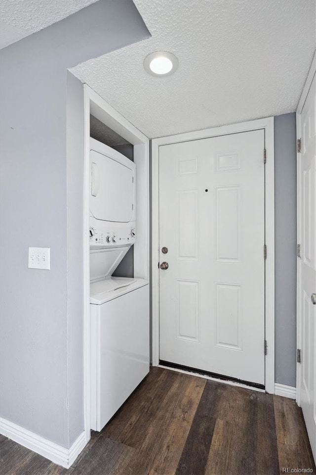 5250 S Huron Way Unit 1-204, Littleton, CO 80120 - laundry area with stacked washer / dryer, a textured ceiling, dark wood finished floors, and baseboards