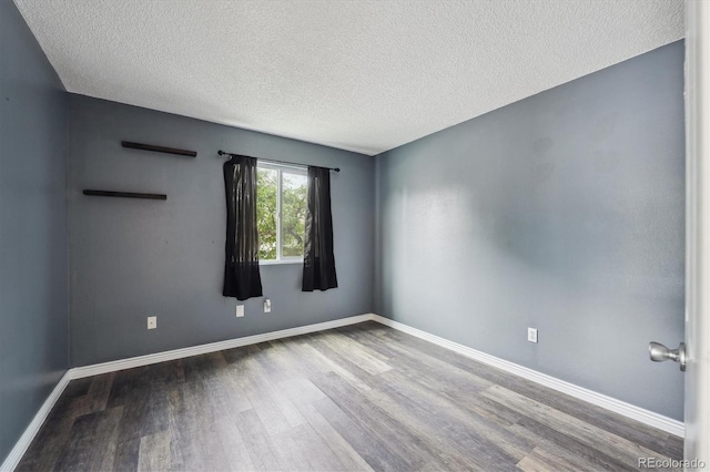 5250 S Huron Way Unit 1-204, Littleton, CO 80120 - unfurnished room featuring wood finished floors, a textured ceiling, and baseboards