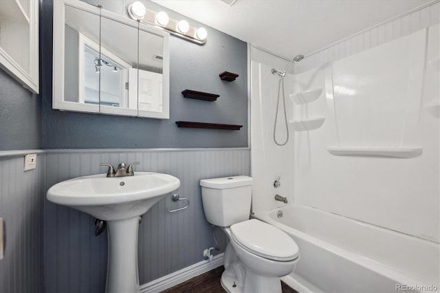 5250 S Huron Way Unit 1-204, Littleton, CO 80120 - bathroom featuring toilet, a wainscoted wall, shower / tub combination, wood finished floors, and baseboards