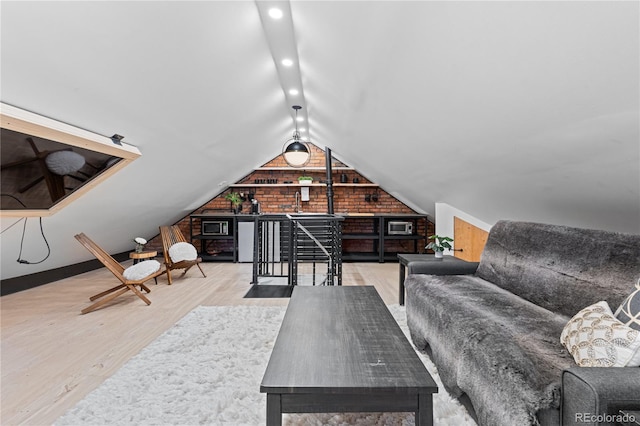 interior space with hardwood / wood-style flooring and lofted ceiling