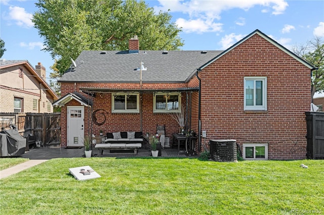 back of house featuring cooling unit and a yard