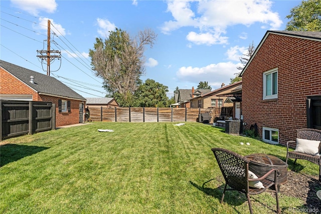 view of yard with a fire pit