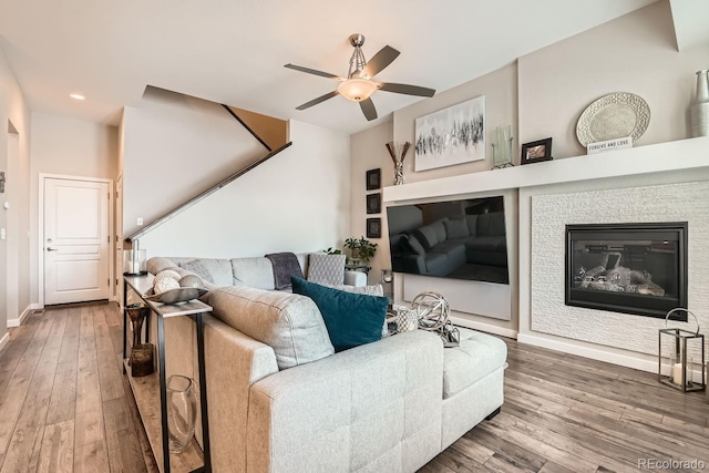 living room featuring hardwood / wood-style flooring and ceiling fan