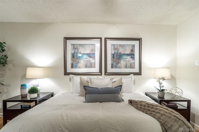 bedroom with baseboards and a textured ceiling