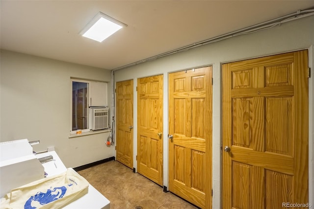interior space featuring cooling unit, baseboards, and multiple closets