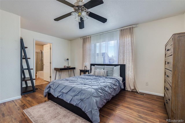 bedroom featuring dark wood-type flooring, ceiling fan, ensuite bath, and a textured ceiling