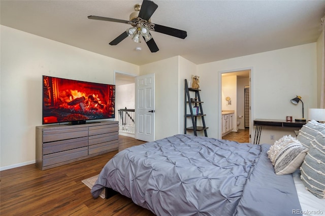 bedroom featuring connected bathroom, hardwood / wood-style floors, and ceiling fan