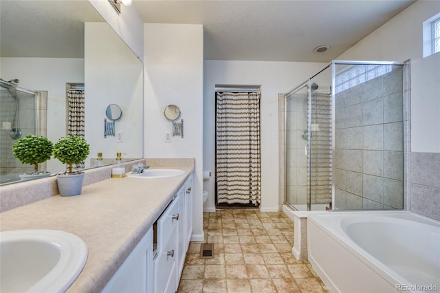 full bathroom featuring vanity, a textured ceiling, shower with separate bathtub, and toilet