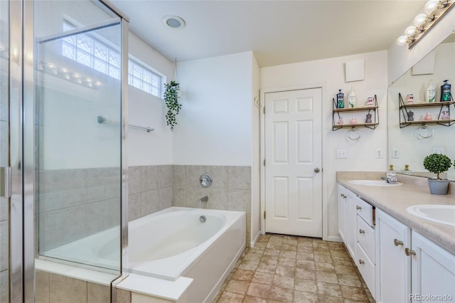 bathroom with a relaxing tiled tub and vanity