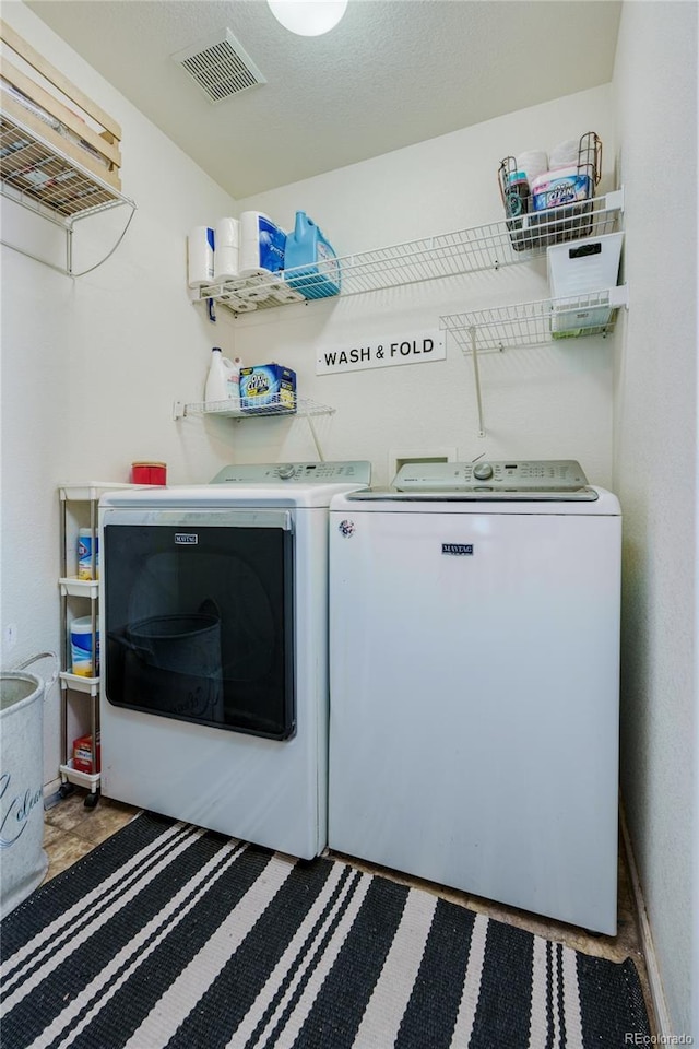 washroom featuring washing machine and dryer