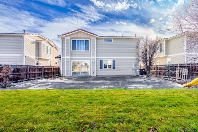 rear view of property featuring a patio area and a lawn