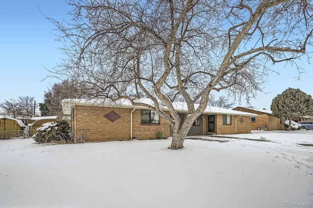 view of snow covered rear of property