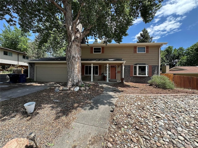 2730 S Jay St, Denver, CO 80227 - traditional home featuring driveway, covered porch, and an attached garage