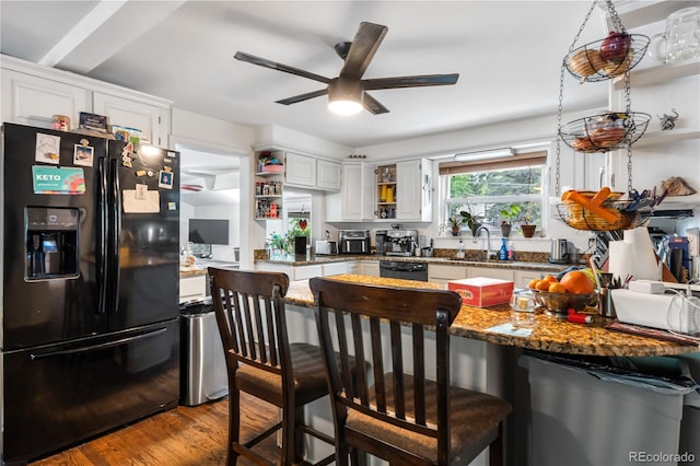 2730 S Jay St, Denver, CO 80227 - kitchen with black appliances, open shelves, wood finished floors, white cabinetry, and ceiling fan