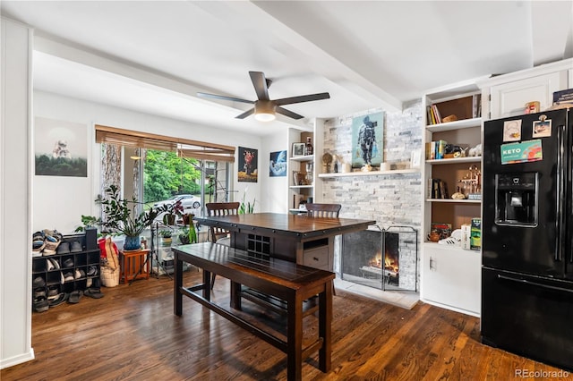 2730 S Jay St, Denver, CO 80227 - dining area featuring a ceiling fan, dark wood-type flooring, beamed ceiling, and a fireplace