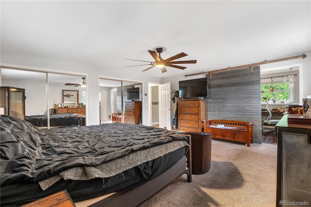 2730 S Jay St, Denver, CO 80227 - carpeted bedroom featuring multiple closets, connected bathroom, and a ceiling fan