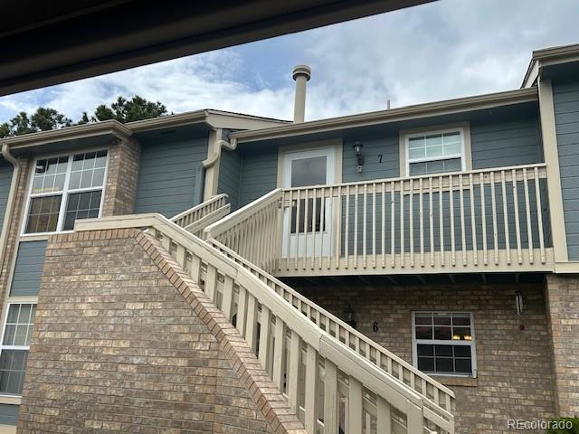 rear view of property with brick siding