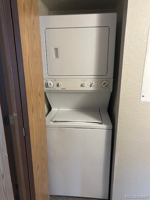 washroom with laundry area and stacked washer and clothes dryer