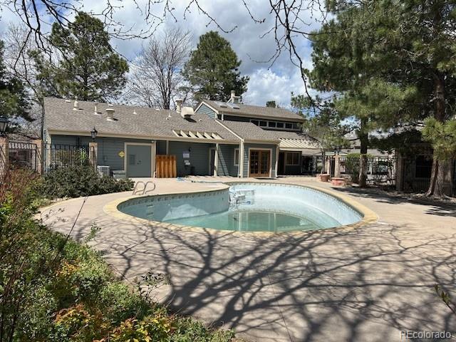 view of swimming pool featuring fence, a fenced in pool, and a patio area