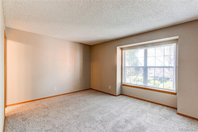 2690 E Otero Pl Unit 7, Centennial, CO 80122 - carpeted spare room featuring a textured ceiling and baseboards