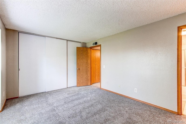 2690 E Otero Pl Unit 7, Centennial, CO 80122 - unfurnished bedroom featuring carpet flooring, a closet, a textured ceiling, and baseboards