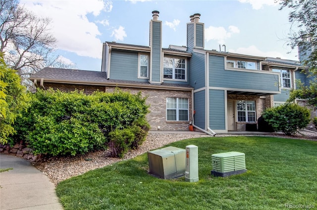 2690 E Otero Pl Unit 7, Centennial, CO 80122 - back of property with brick siding, a yard, and a chimney