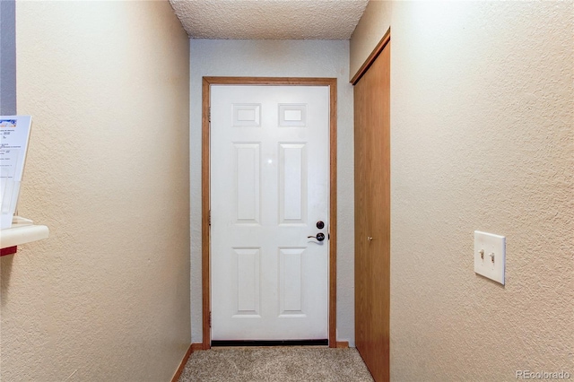 2690 E Otero Pl Unit 7, Centennial, CO 80122 - doorway to outside with carpet and a textured wall